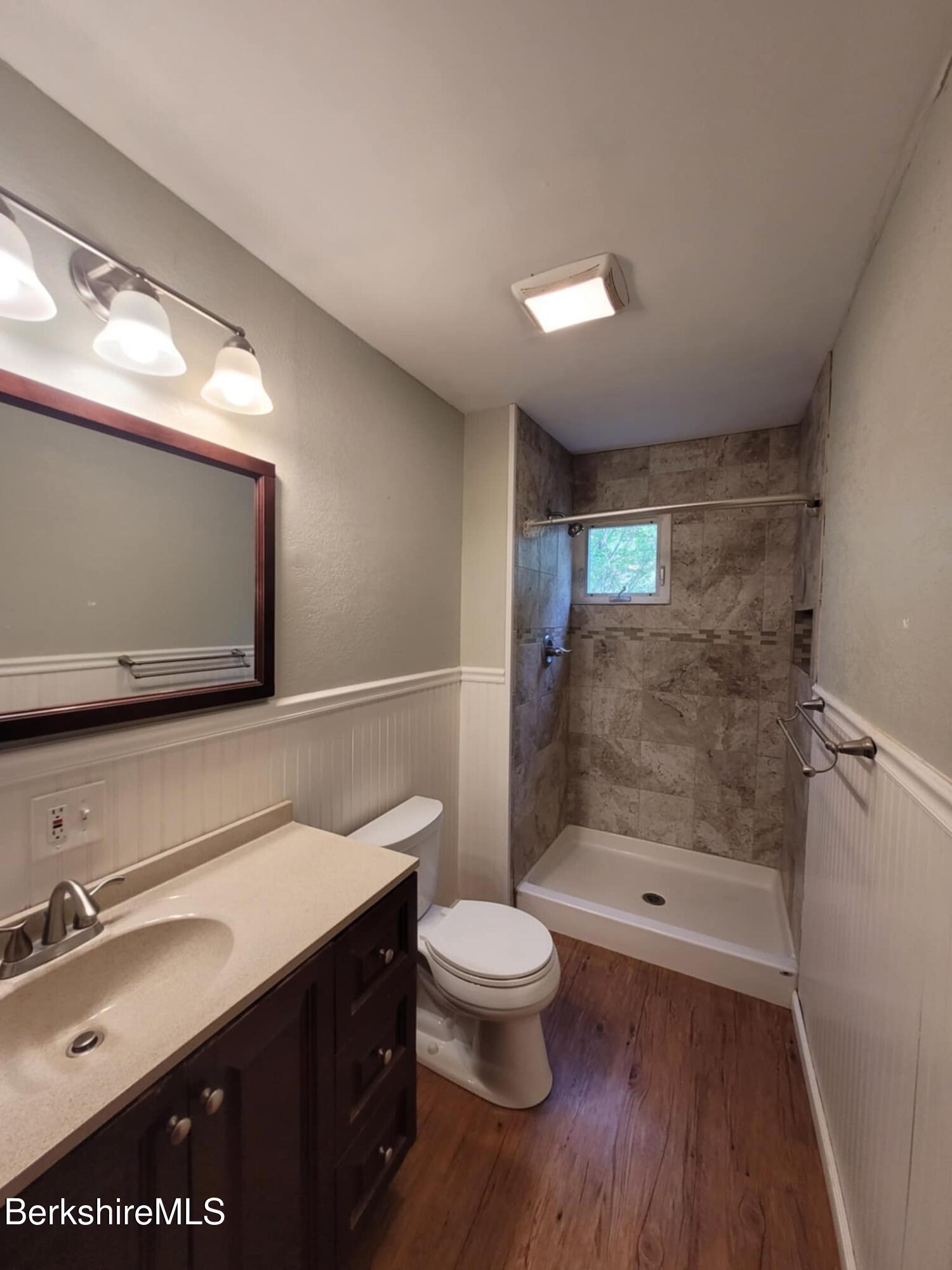 14 Pine Street Adams, MA 01220 - Photo 7 of 8 a bathroom with a sink a toilet a mirror and shower
