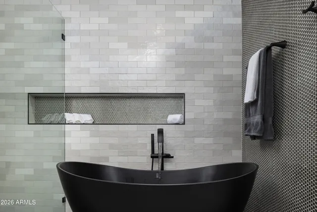 a bathroom with a granite countertop shower mirror and a sink