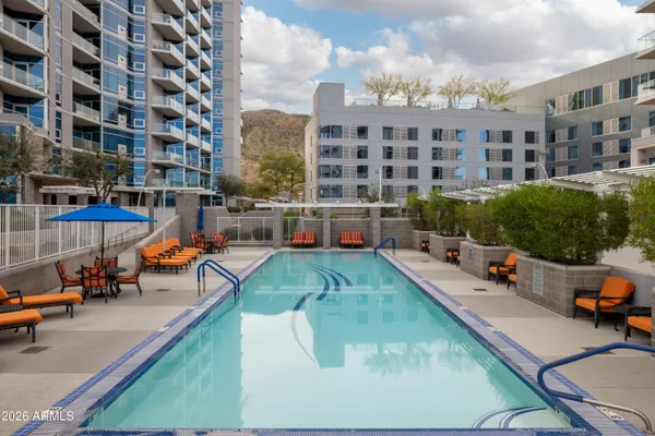 a view of building with swimming pool and sitting area