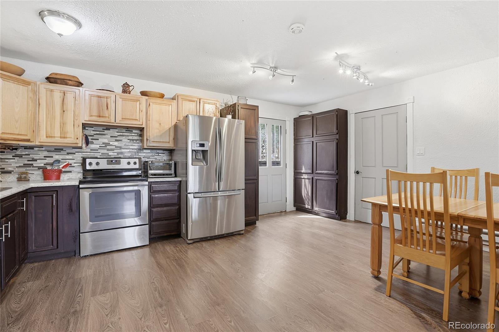 9225 Sandy Lane Conifer, CO 80433 - Photo 29 of 45 a kitchen with granite countertop a refrigerator and a stove top oven