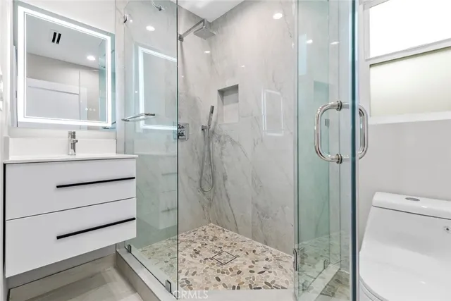 a bathroom with a shower sink and mirror