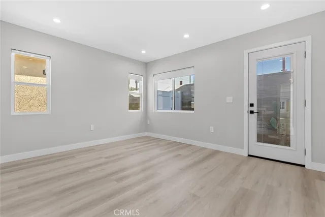 a view of wooden floor and windows in a room