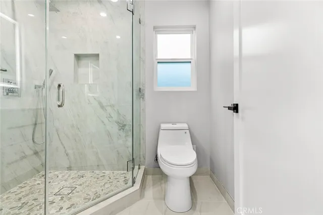a bathroom with a shower sink and mirror
