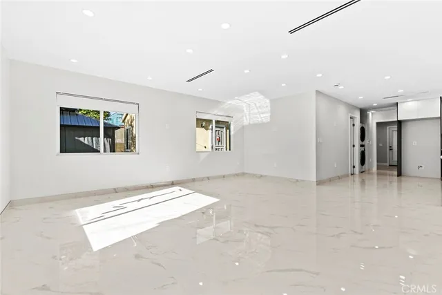 a view of kitchen with refrigerator and window