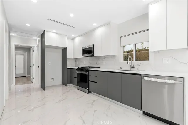 a kitchen with stainless steel appliances granite countertop a stove and a refrigerator
