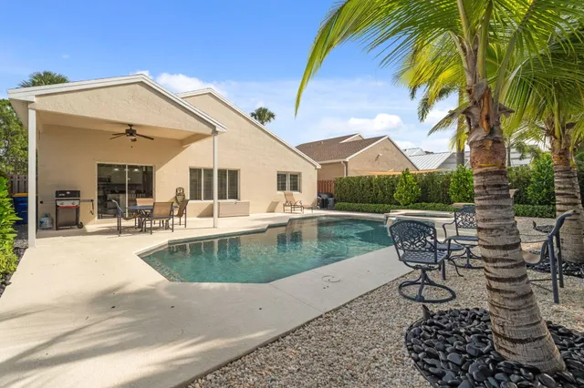 a view of a house with pool porch and sitting area