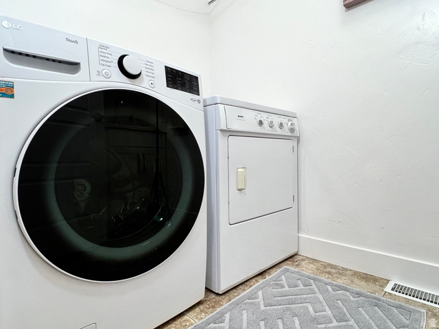 1017 South 275 West Logan, UT 84321 - Photo 22 of 36 Laundry room with baseboards and washing machine and clothes dryer