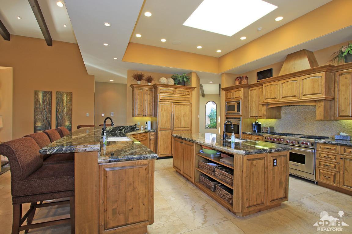 57300 Peninsula Lane La Quinta, CA 92253 - Photo 26 of 97 a kitchen with stainless steel appliances granite countertop a stove and a refrigerator
