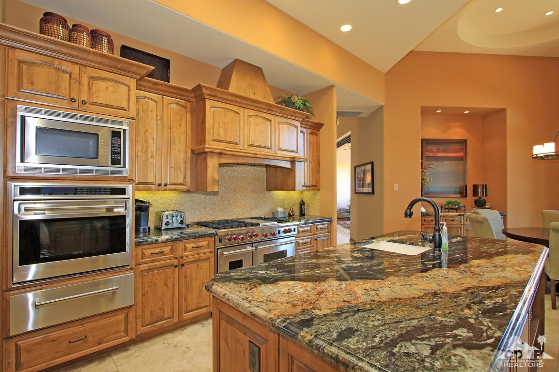 57300 Peninsula Lane La Quinta, CA 92253 - Photo 30 of 97 a kitchen with stainless steel appliances granite countertop a sink stove and cabinets