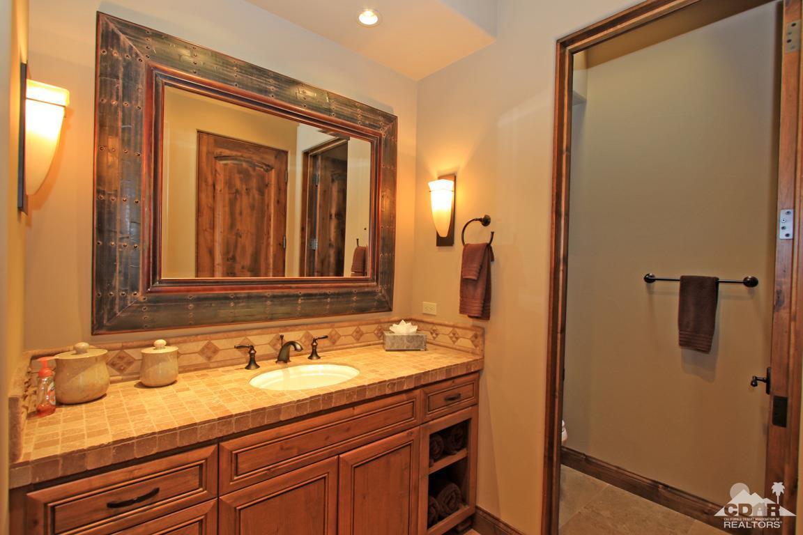 57300 Peninsula Lane La Quinta, CA 92253 - Photo 49 of 97 a bathroom with a granite countertop sink and mirror
