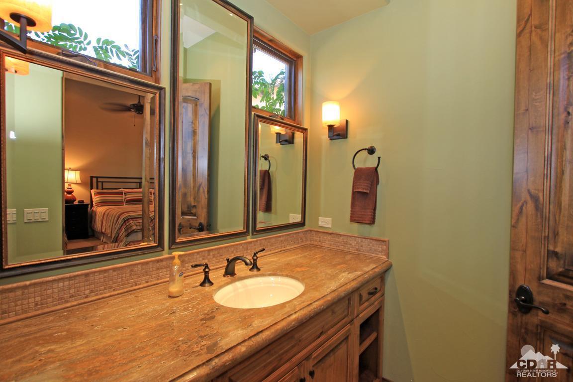 57300 Peninsula Lane La Quinta, CA 92253 - Photo 52 of 97 a bathroom with a granite countertop sink and a mirror