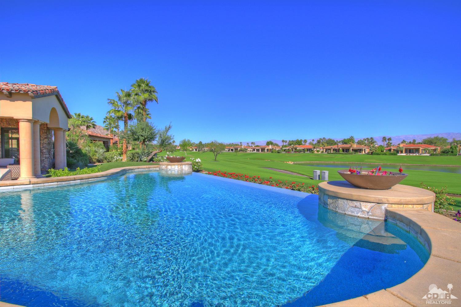 57300 Peninsula Lane La Quinta, CA 92253 - Photo 73 of 97 a view of a swimming pool and lounge chairs