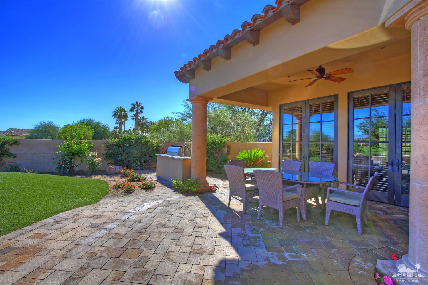 57300 Peninsula Lane La Quinta, CA 92253 - Photo 84 of 97 a view of a patio with a table chairs and a backyard