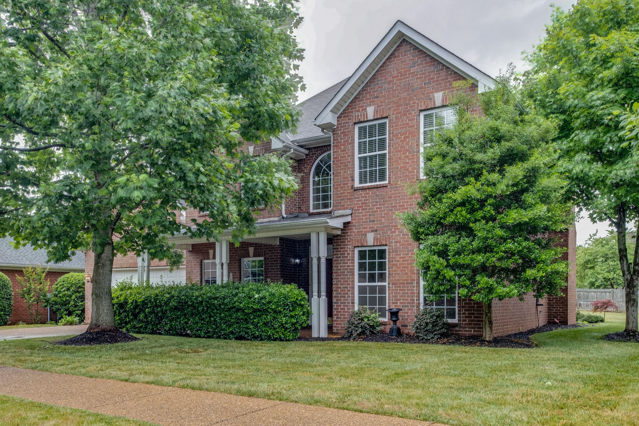 108 Berwick Place Franklin, TN 37064 - Photo 1 of 28 a front view of a house with a yard and trees