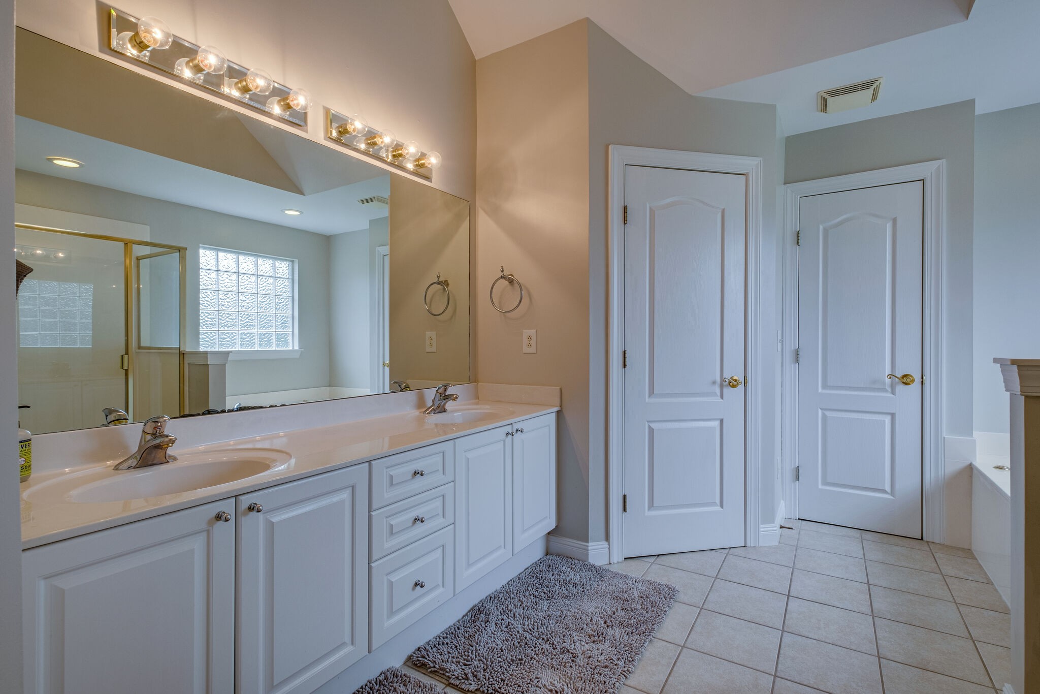 108 Berwick Place Franklin, TN 37064 - Photo 18 of 28 a spacious bathroom with a double vanity sink a mirror and a shower