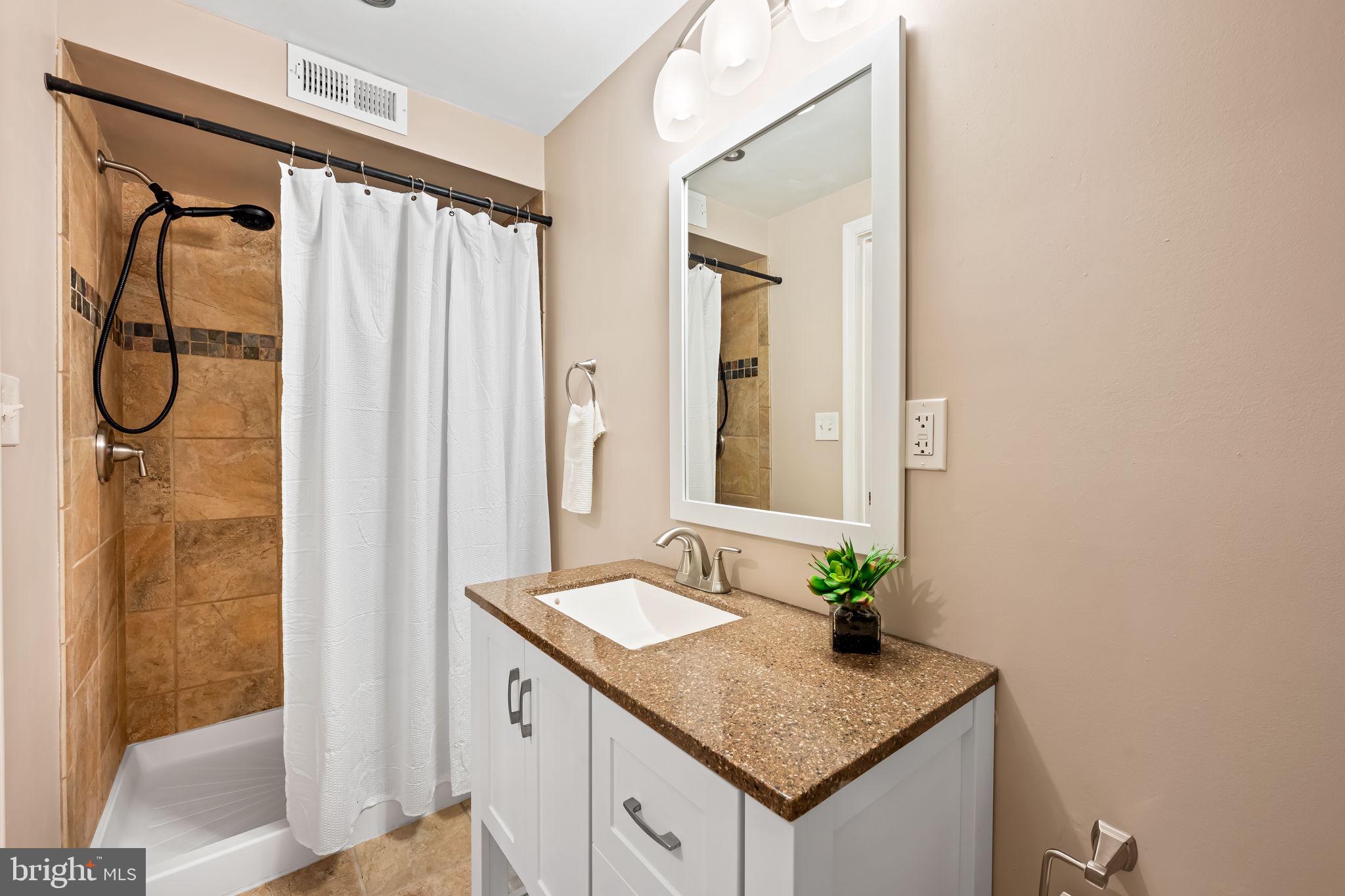 1817 Dunmere Road Baltimore, MD 21222 - Photo 22 of 27 a bathroom with a granite countertop sink and a mirror