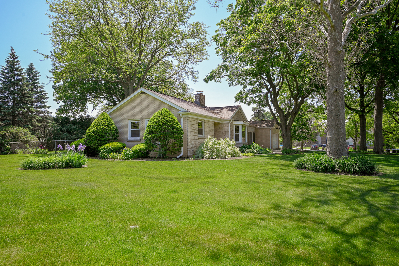 325 South Lambert Road Glen Ellyn, IL 60137 - Photo 5 of 32 a front view of a house with a garden and yard