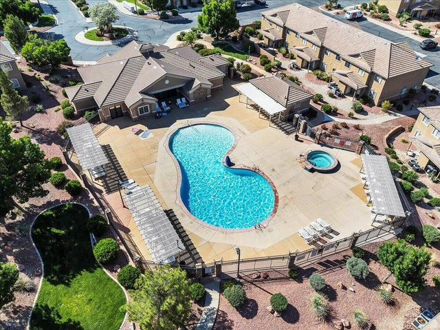 3155 South Hidden Dr Street, Unit 248 St. George, UT 84790 - Photo 2 of 24 Resort-style pool area featuring a freeform swimming pool, integrated spa, and expansive concrete decking