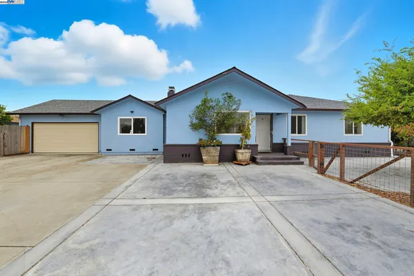 a view of house with yard and entertaining space