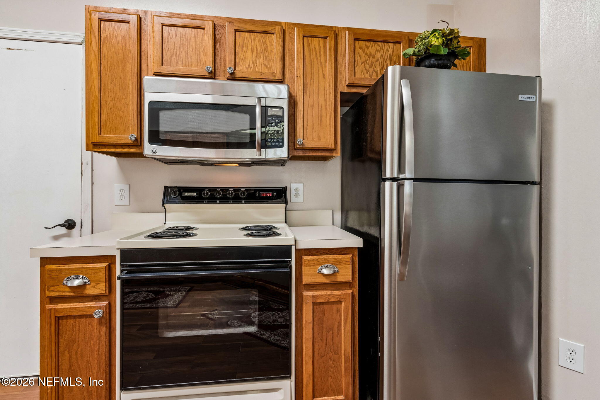 12648 Moose Road Jacksonville, FL 32226 - Photo 13 of 38 a kitchen with a stove and a refrigerator