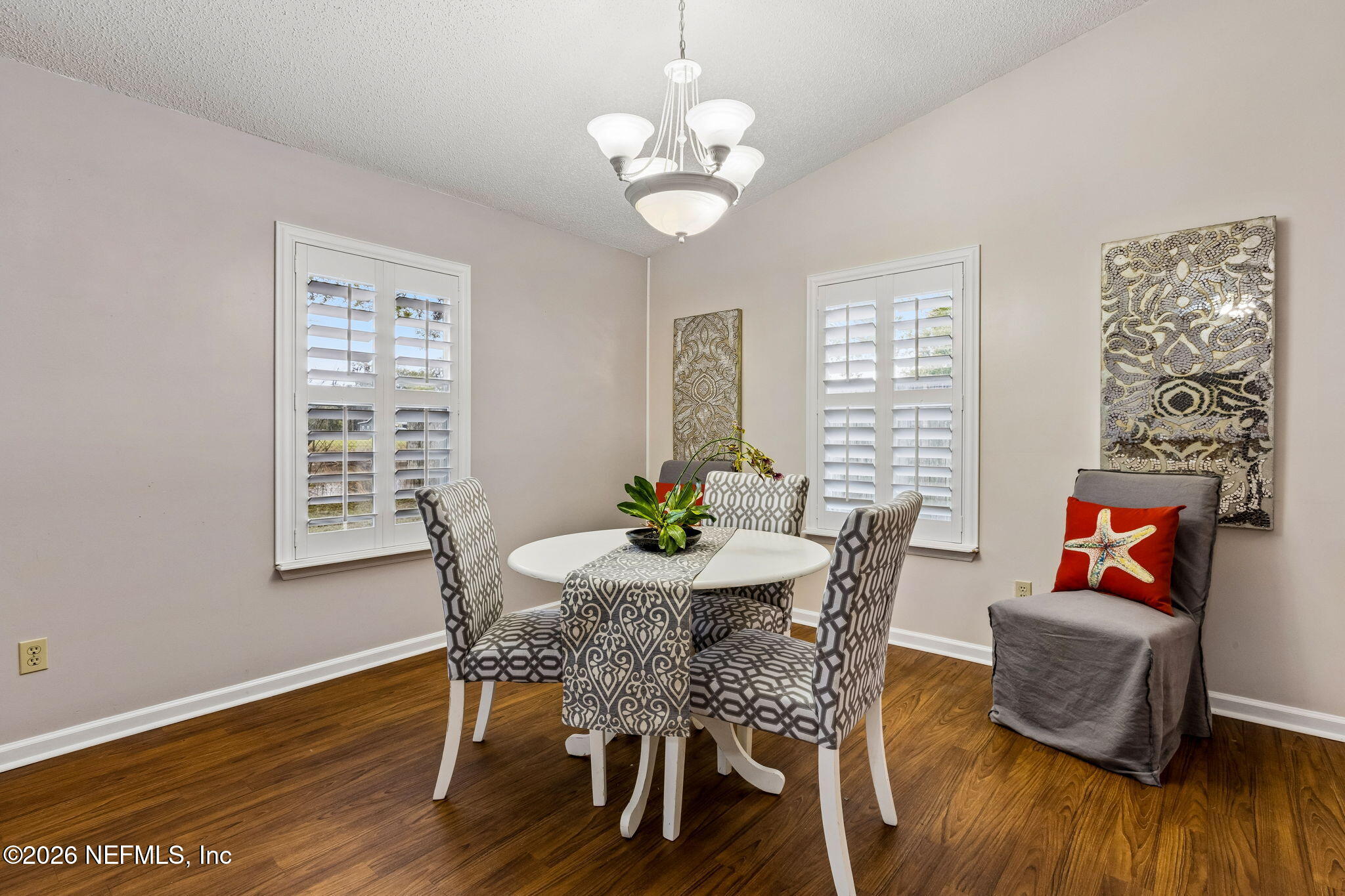 12648 Moose Road Jacksonville, FL 32226 - Photo 17 of 38 a view of a dining room with furniture wooden floor and a chandelier