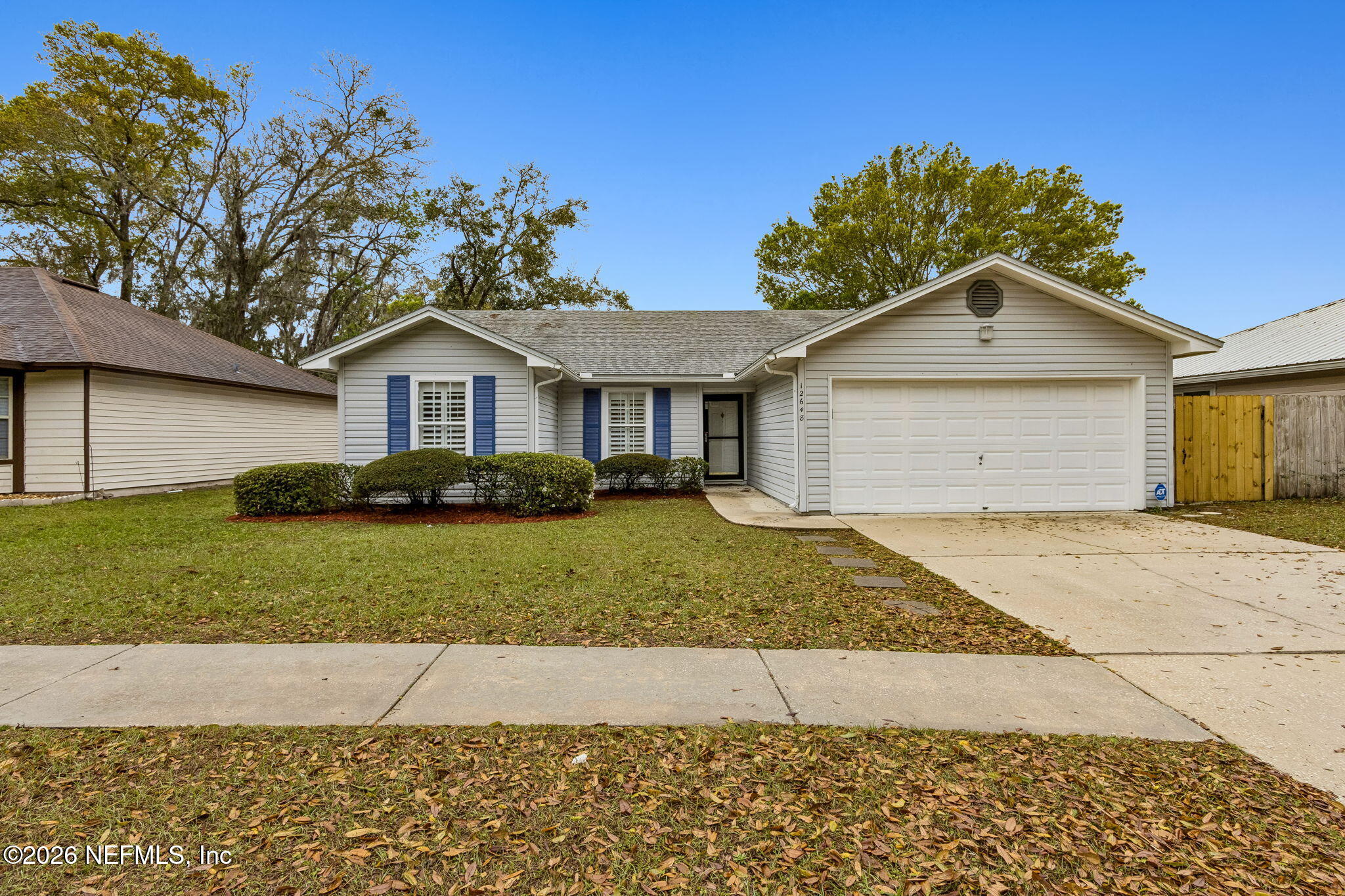 12648 Moose Road Jacksonville, FL 32226 - Photo 2 of 38 a front view of a house with a yard and garage