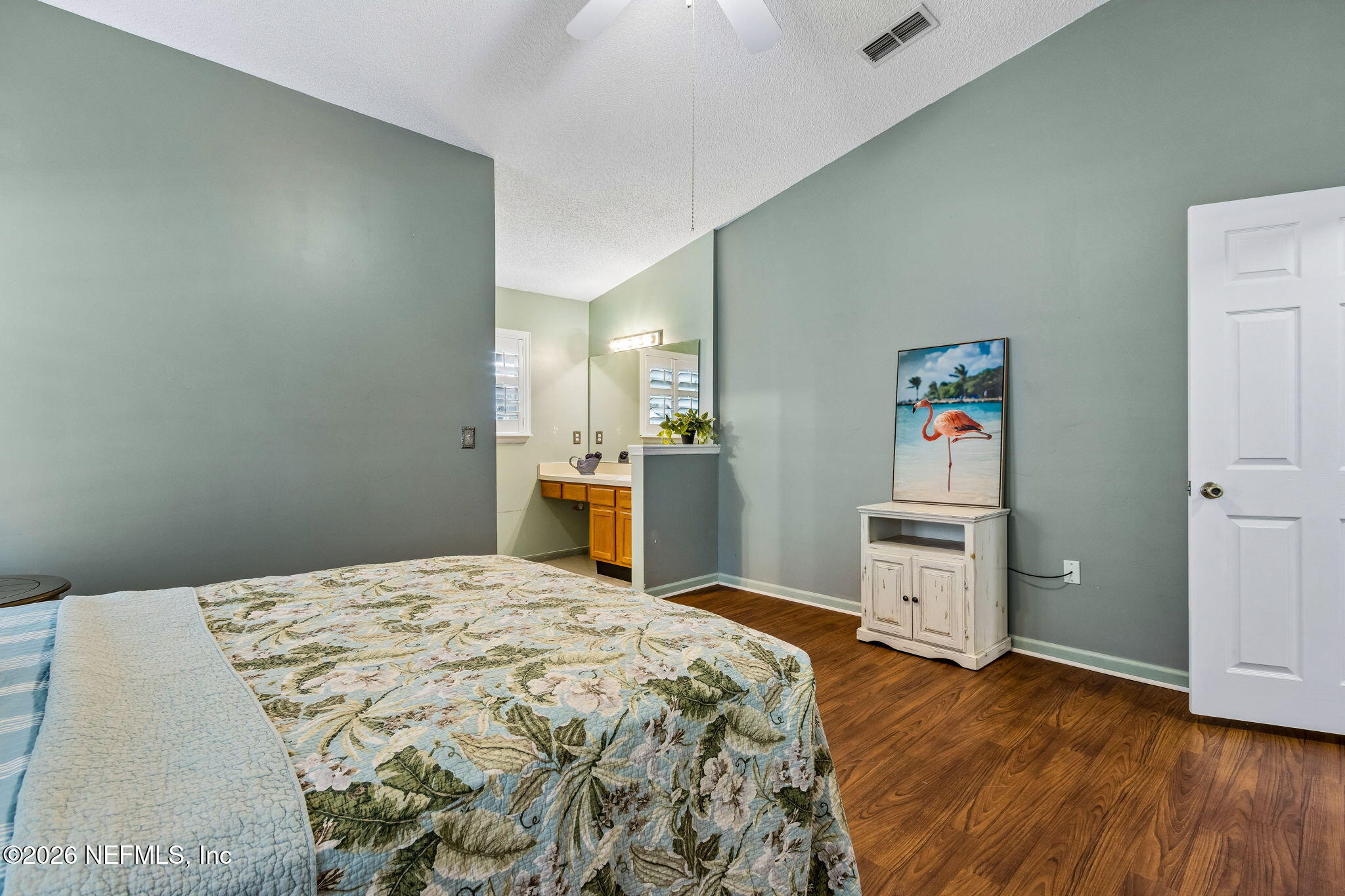 12648 Moose Road Jacksonville, FL 32226 - Photo 22 of 38 a spacious bedroom with a bed and a view of kitchen