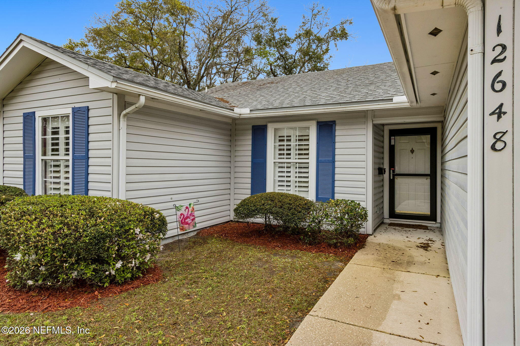 12648 Moose Road Jacksonville, FL 32226 - Photo 5 of 38 a front view of a house with garden