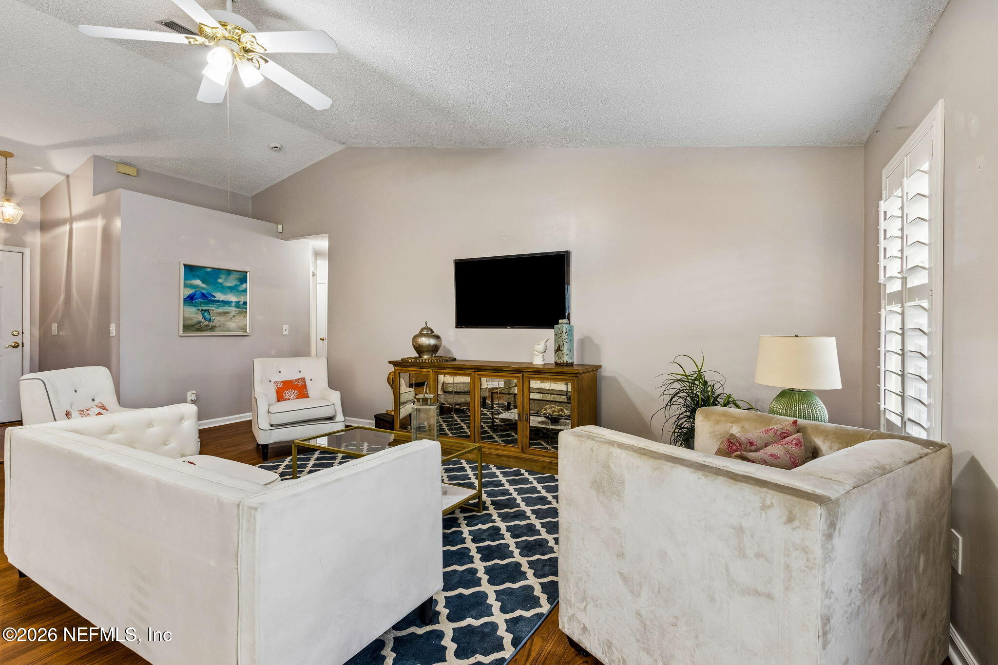 12648 Moose Road Jacksonville, FL 32226 - Photo 7 of 38 a living room with furniture and a flat screen tv