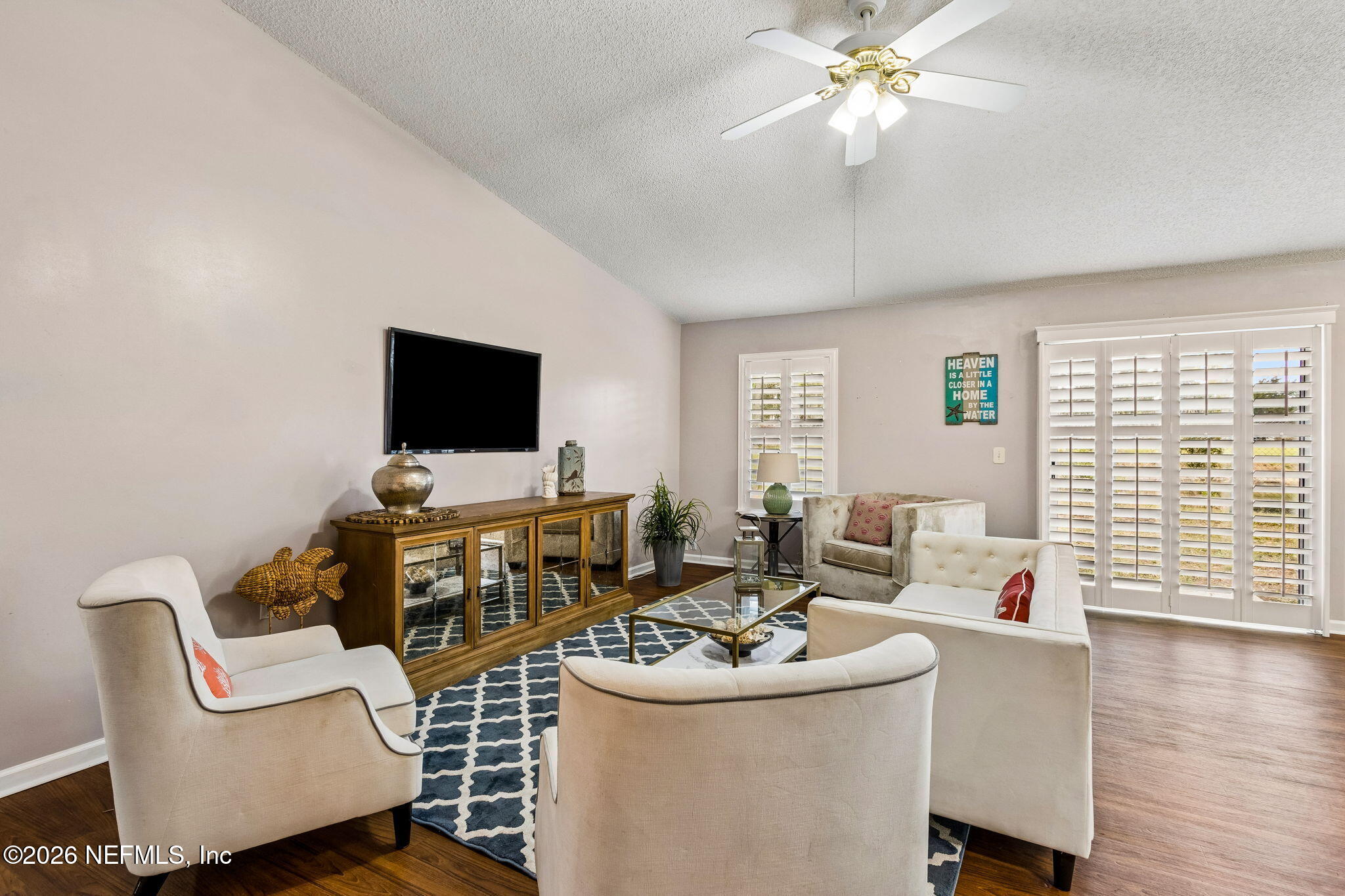 12648 Moose Road Jacksonville, FL 32226 - Photo 8 of 38 a living room with furniture and a flat screen tv