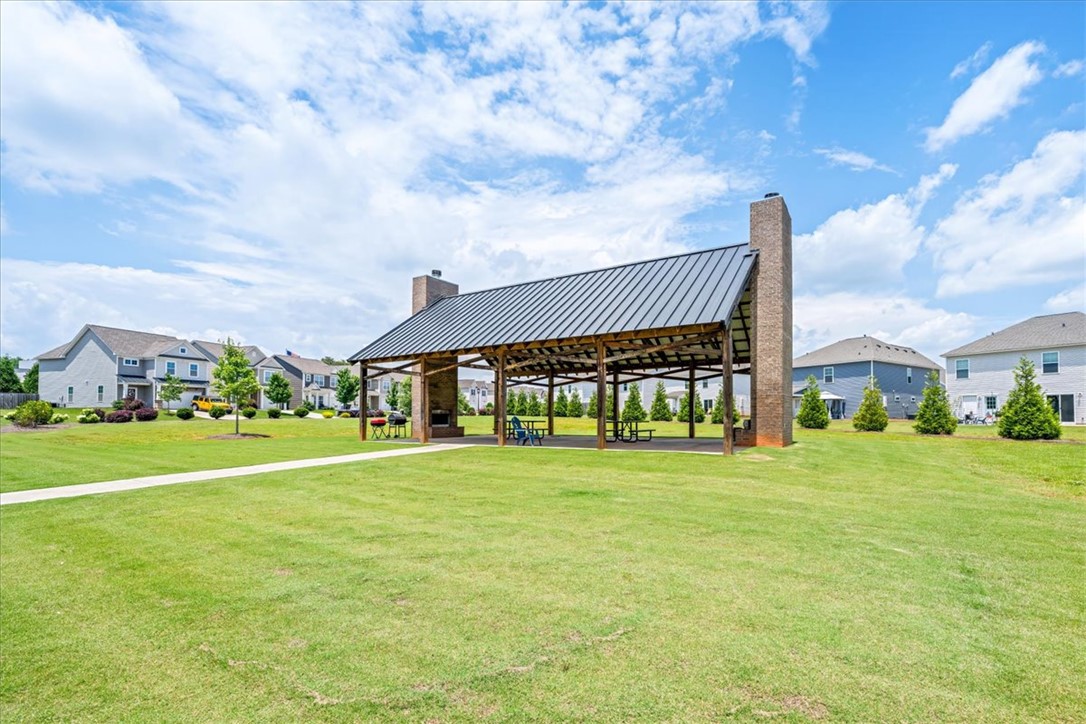 115 Adger Road Pendleton, SC 29670 - Photo 29 of 36 A spacious community pavilion with a metal roof and brick pillars offers an ideal gathering spot amidst verdant grounds.