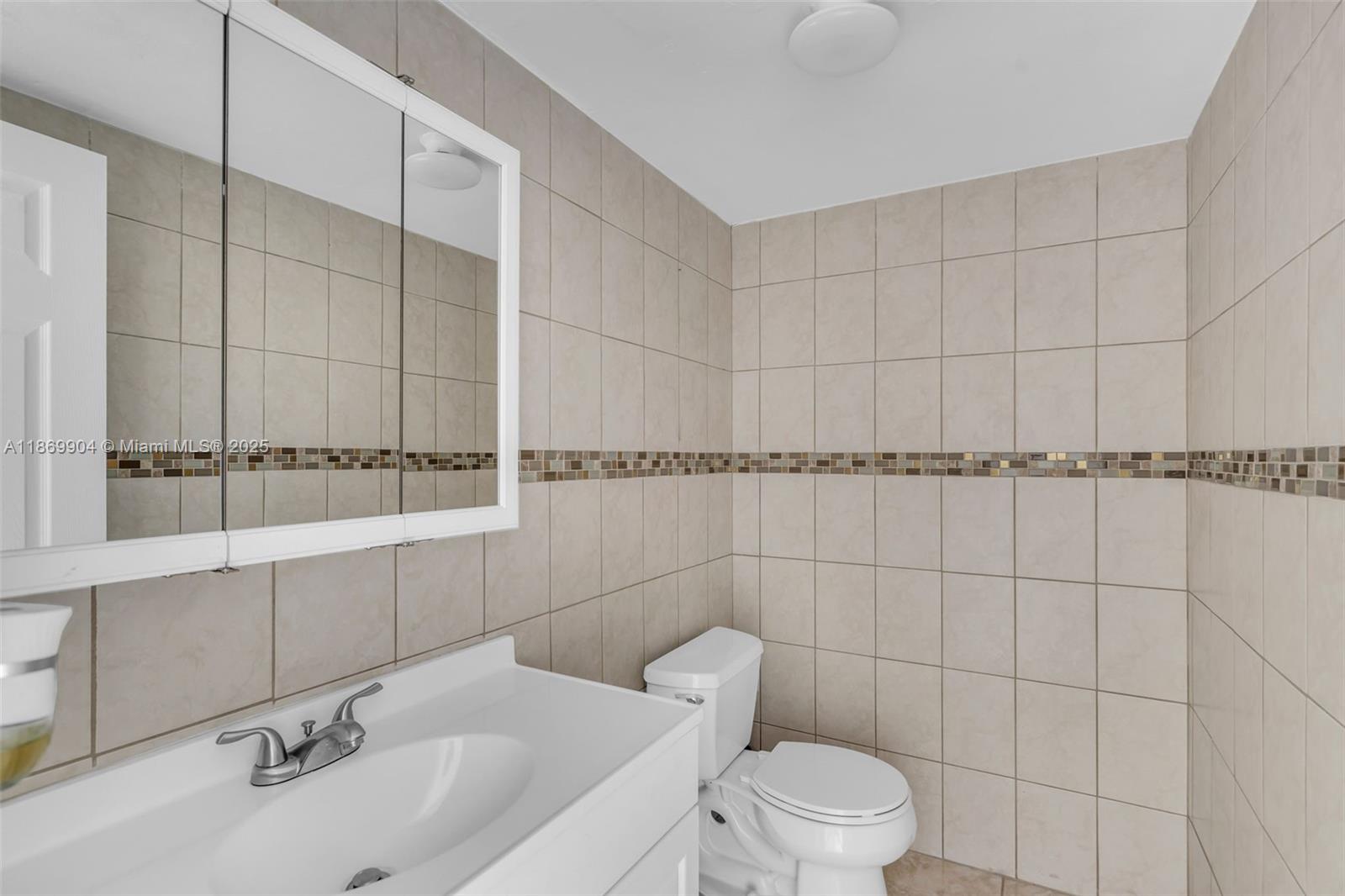 13499 Biscayne Boulevard, Unit 403 North Miami, FL 33181 - Photo 18 of 31 a bathroom with a toilet and a sink