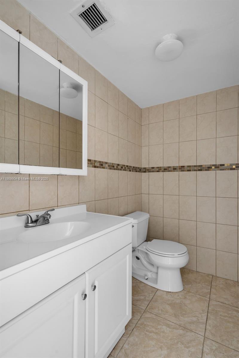 13499 Biscayne Boulevard, Unit 403 North Miami, FL 33181 - Photo 19 of 31 a bathroom with a sink toilet and shower