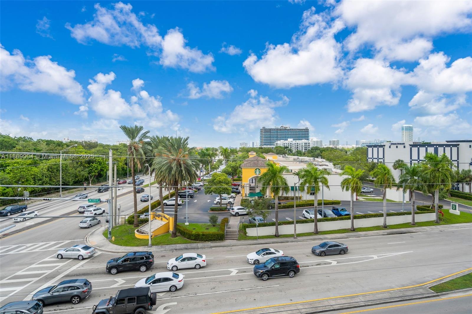 13499 Biscayne Boulevard, Unit 403 North Miami, FL 33181 - Photo 22 of 31 a view of a tennis ground with large trees