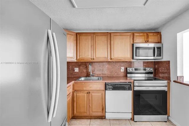 a kitchen with a stove top oven and sink