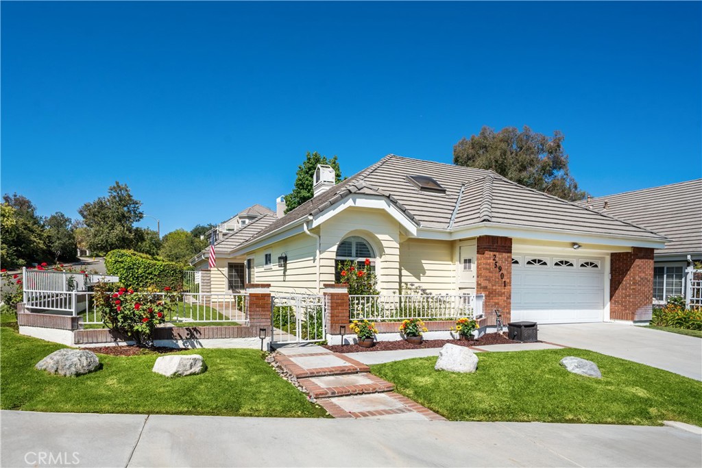 25901 Bellis Drive Valencia, CA 91355 - Photo 1 of 1 a front view of house with yard and outdoor seating