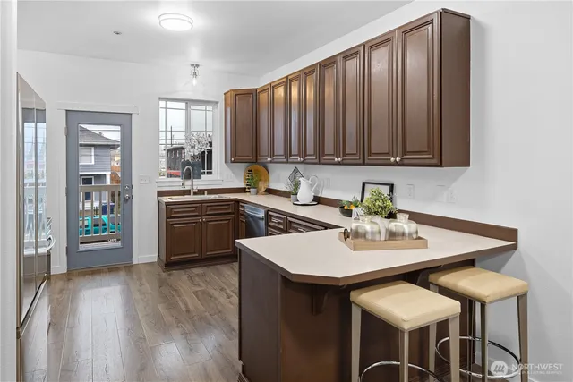 a kitchen with a sink cabinets and wooden floor