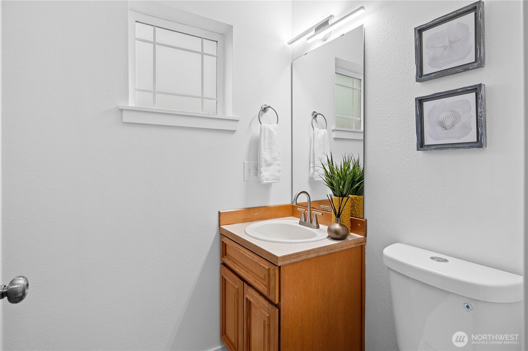 5621 South Lawrence Street, Unit C Tacoma, WA 98409 - Photo 15 of 29 a bathroom with a sink a toilet and mirror