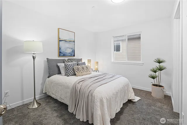 a bedroom with bed and a potted plant