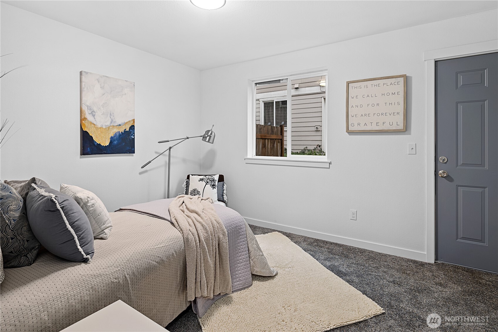 5621 South Lawrence Street, Unit C Tacoma, WA 98409 - Photo 25 of 29 a bed sitting in a bedroom next to a window