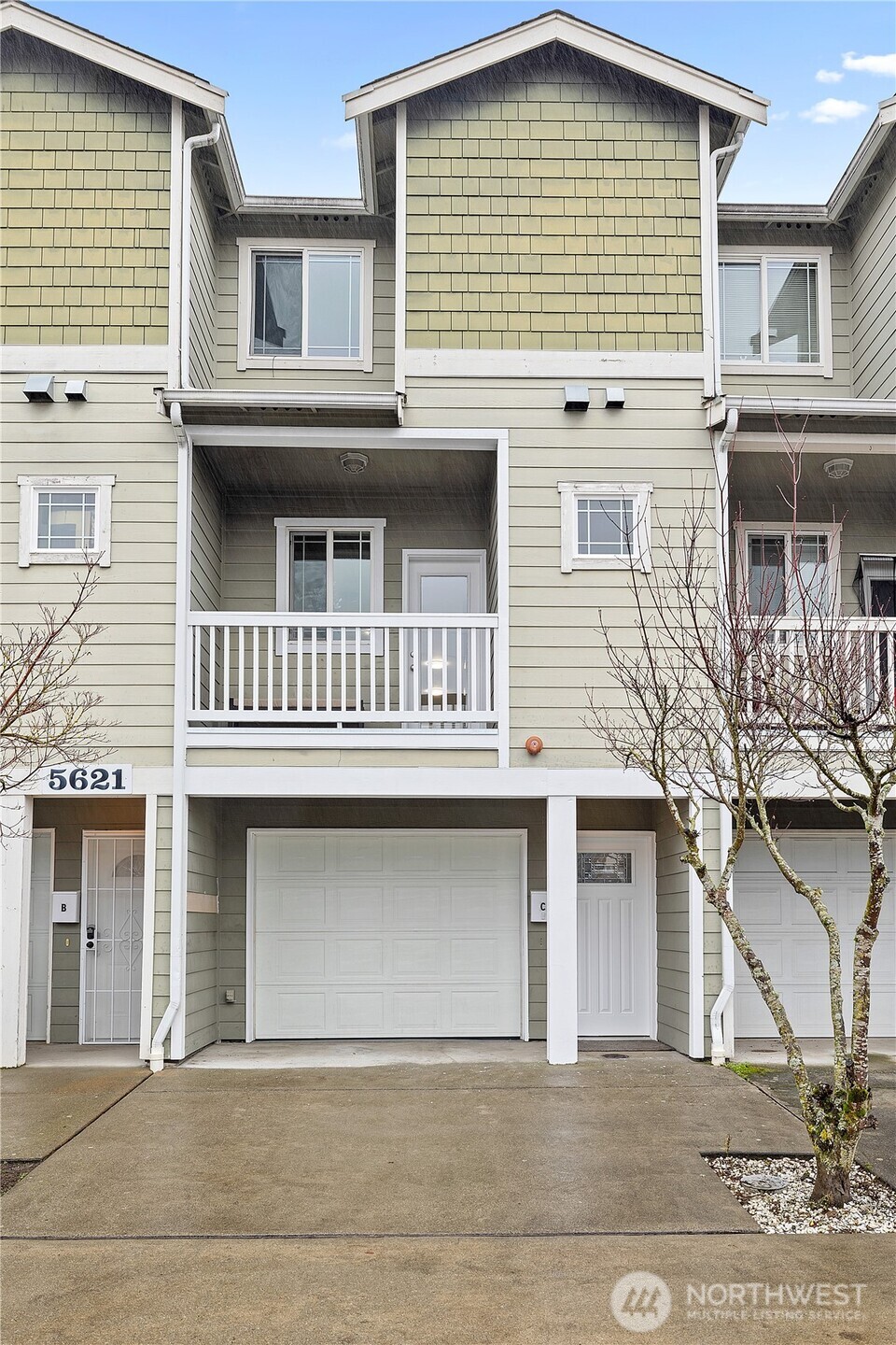 5621 South Lawrence Street, Unit C Tacoma, WA 98409 - Photo 4 of 29 a front view of a house with a garage