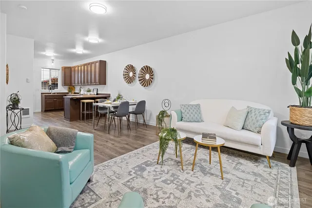 a living room with furniture and wooden floor