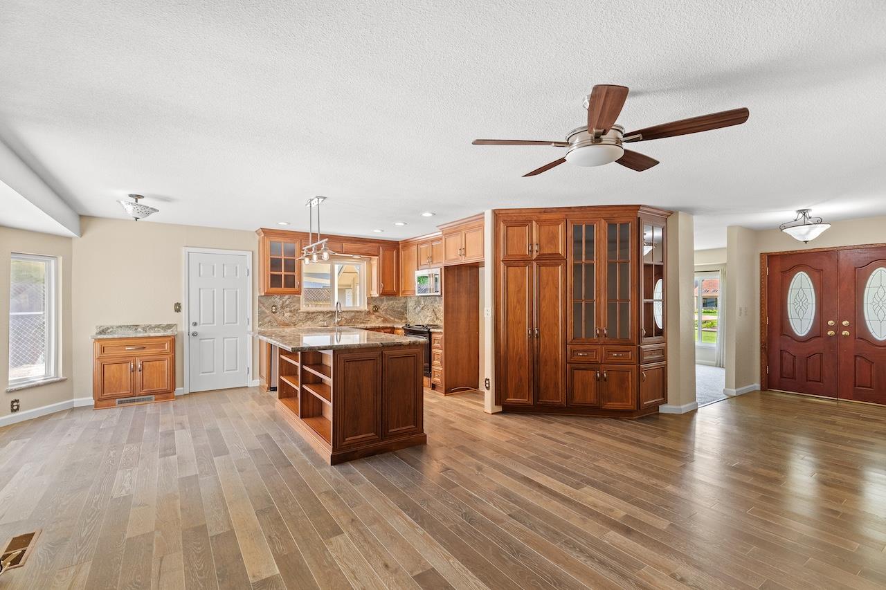 940 Constitution Way Tracy, CA 95376 - Photo 16 of 63 a view of a kitchen with stainless steel appliances wooden floor and chair