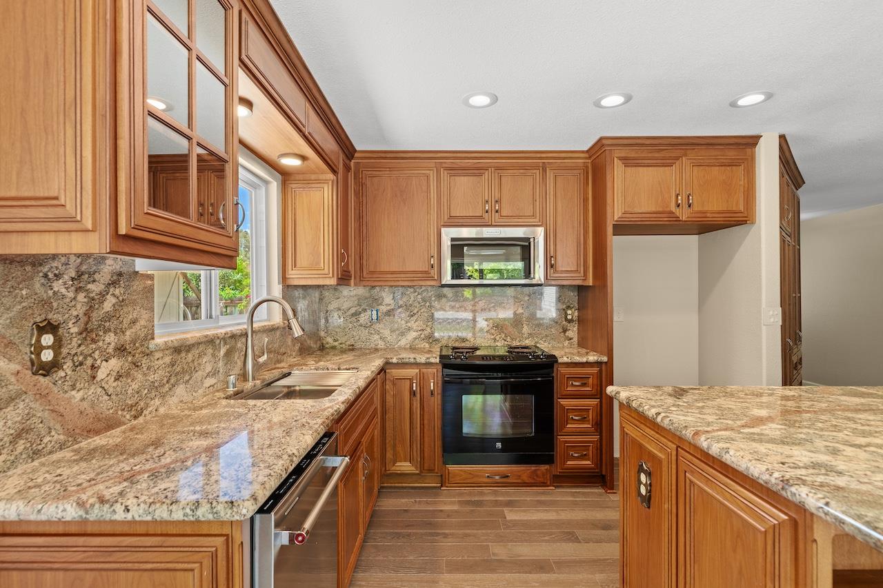 940 Constitution Way Tracy, CA 95376 - Photo 20 of 63 a kitchen with stainless steel appliances granite countertop a stove and a sink