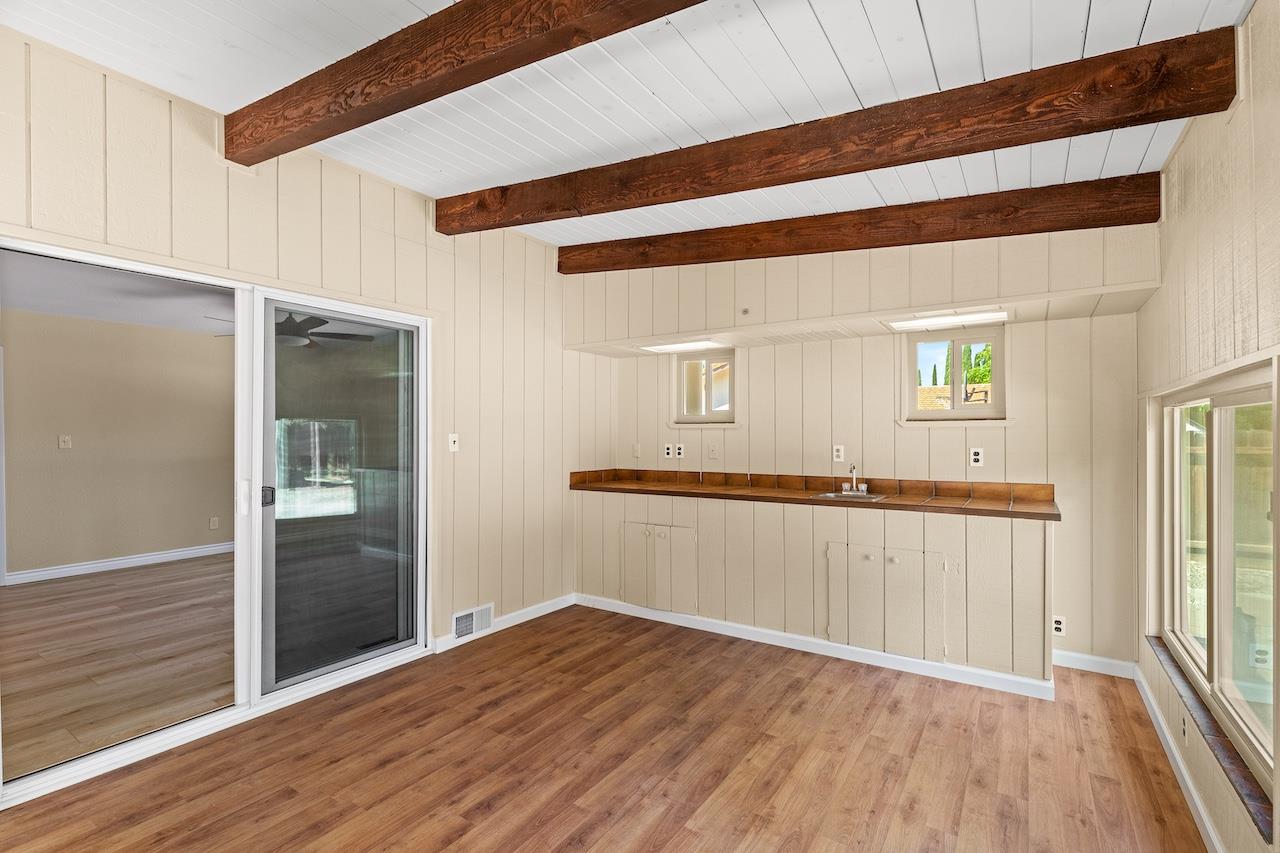 940 Constitution Way Tracy, CA 95376 - Photo 33 of 63 a view of an empty room with wooden floor and a window