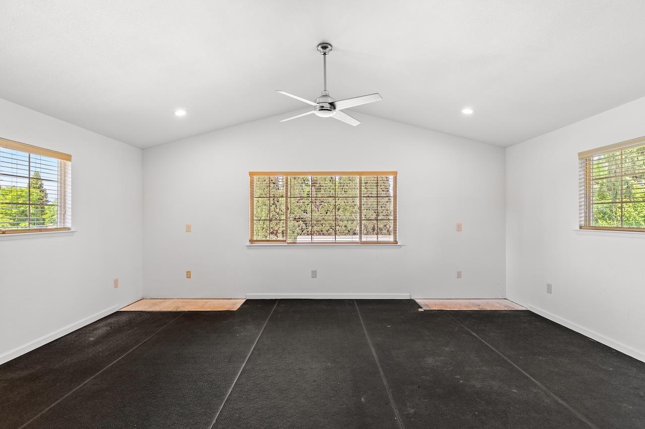 940 Constitution Way Tracy, CA 95376 - Photo 57 of 63 an empty room with a window and a ceiling fan