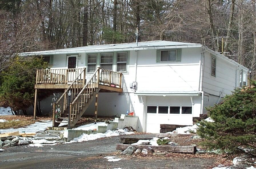 137 Locust Road Dingmans Ferry, PA 18328 - Photo 1 of 1 a front view of a house with a yard