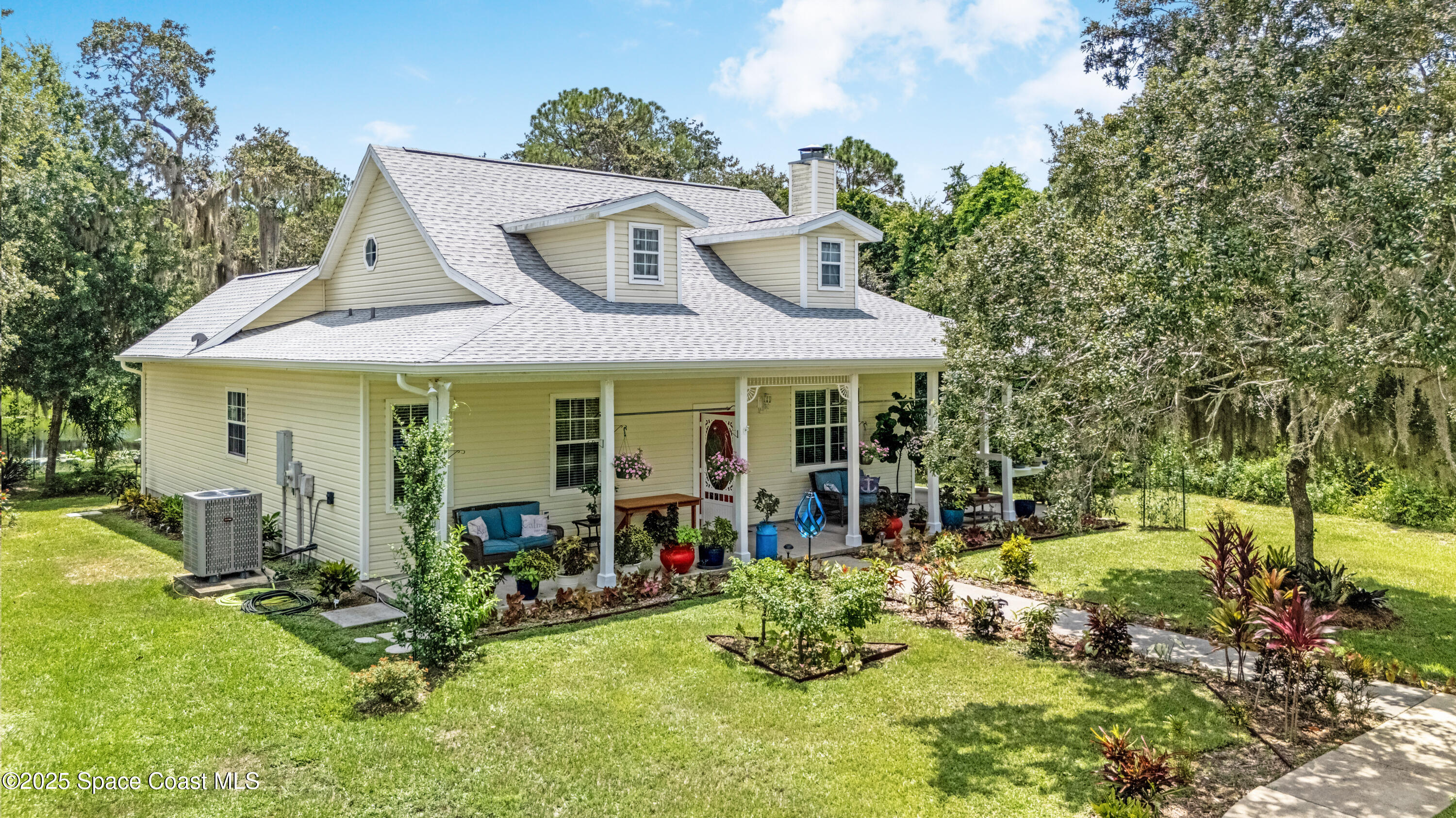 a front view of house with yard seating and green space