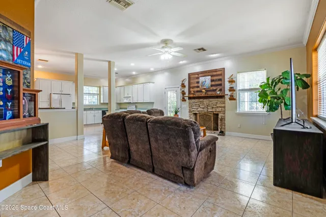 a living room with furniture a fireplace and a flat screen tv
