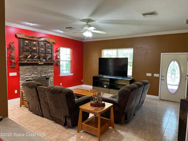 a living room with furniture a large window and a flat screen tv